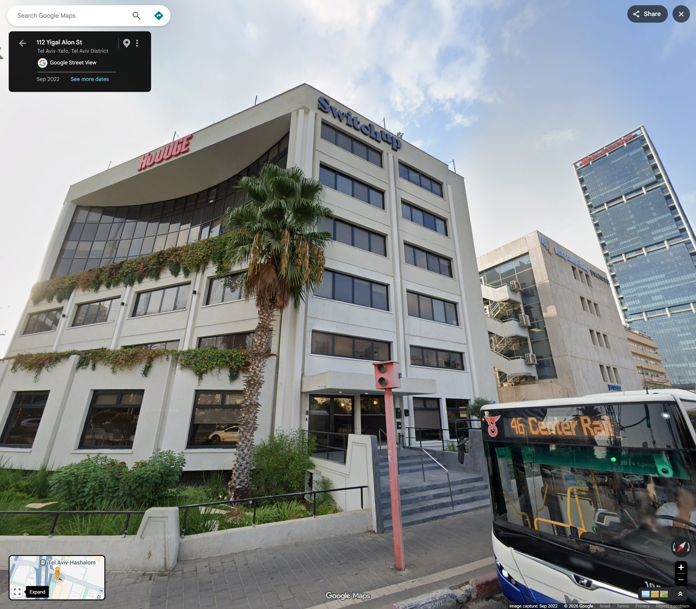 Whole photograph of Microdaf and its entrance, with a pole and bus obscuring parts